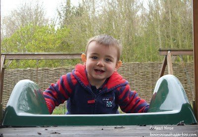 A young boy sitting on a bench