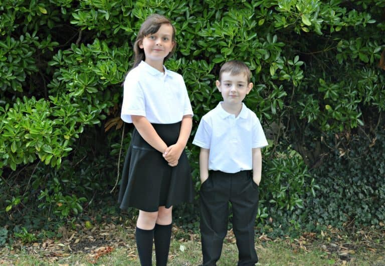A young boy standing in front of a tree