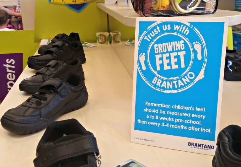 A group of people standing on top of a suitcase