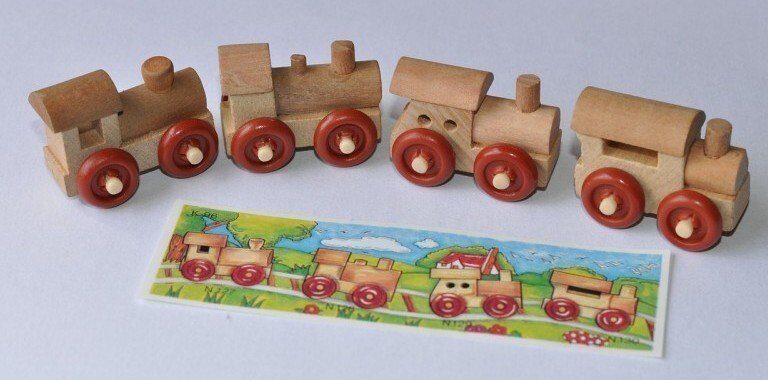 A train cake sitting on top of a wooden table