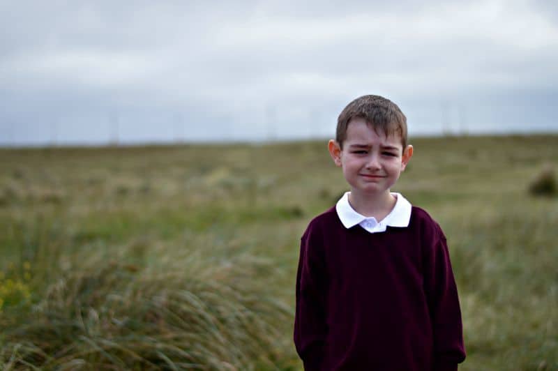 A young boy standing on a field