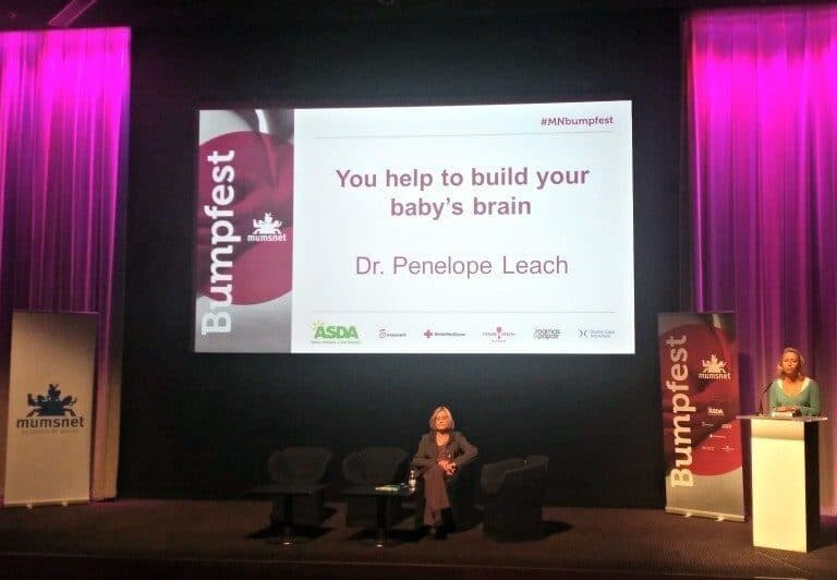 A person sitting at a desk in front of a stage