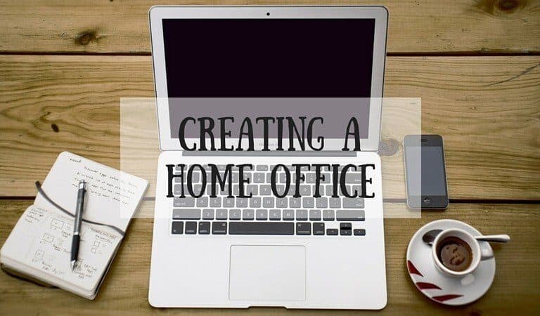 A computer sitting on top of a wooden table