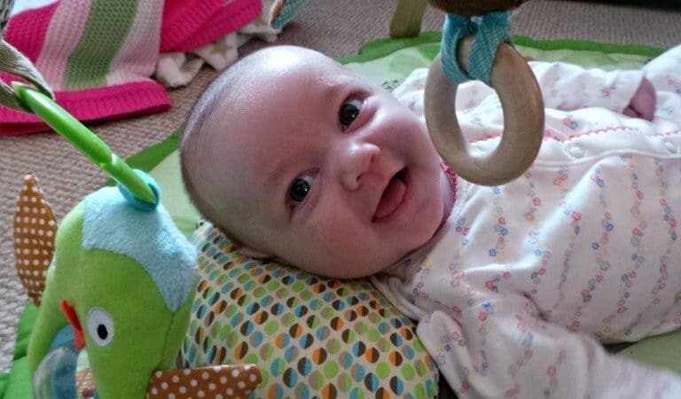 A baby lying on a bed