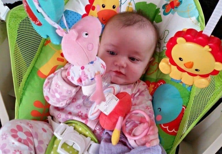 A baby holding a stuffed animal