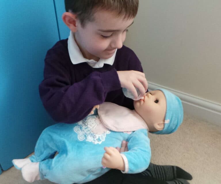 A young boy holding a teddy bear