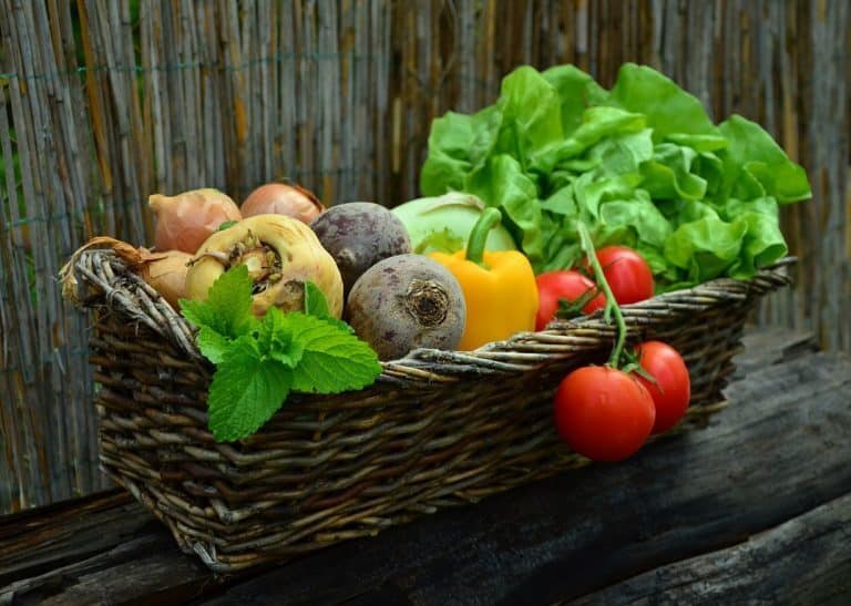 A bowl of fruit on a wooden table, with Produce and Salad