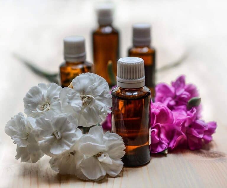 A close up of a glass vase on a table, with Oil