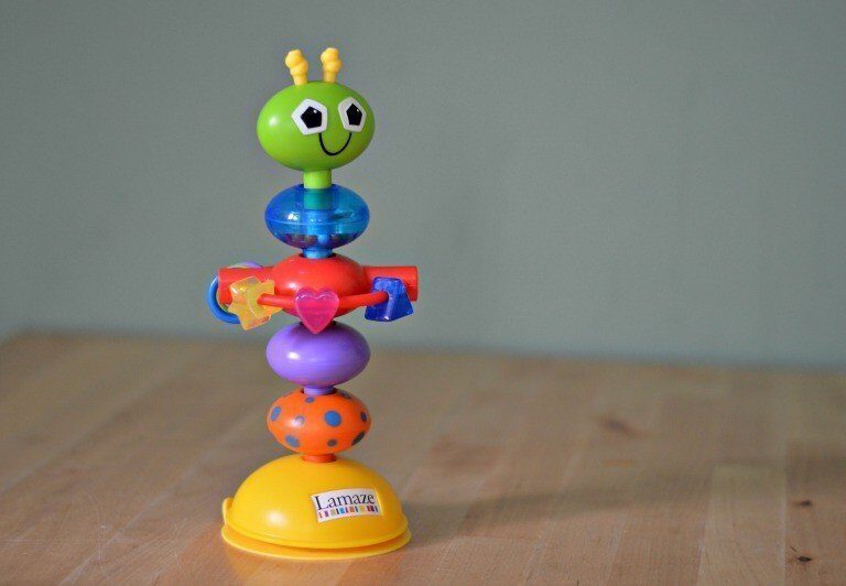 A toy on a cutting board with a cake, with Roo and Tigger