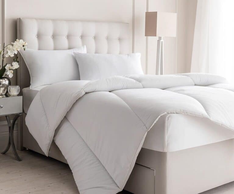 A bedroom with a large bed in a room