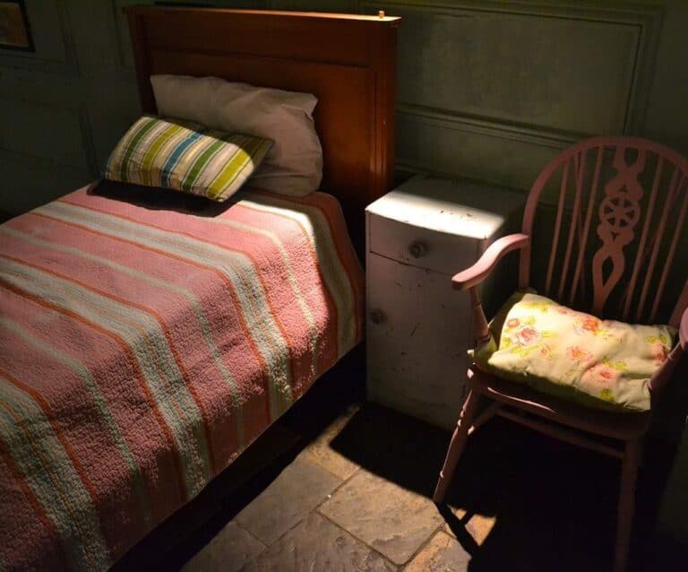 A bedroom with a bed in a room