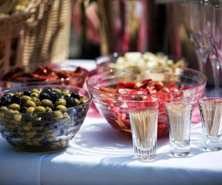 A group of glass bottles on a table, with Restaurant