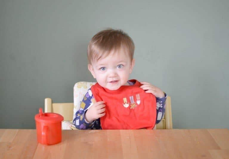 A little boy sitting on a table