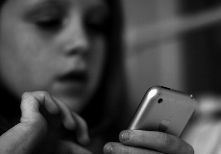 A close up of a person holding a cell phone