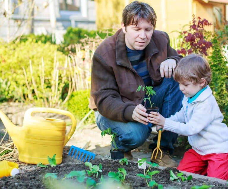 A small child is sitting in the grass