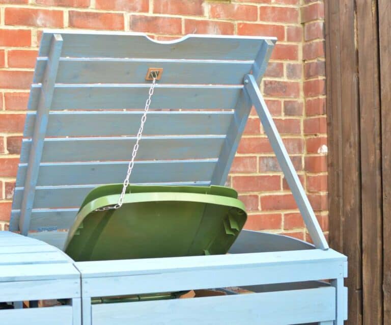 A wooden bench sitting in front of a brick building