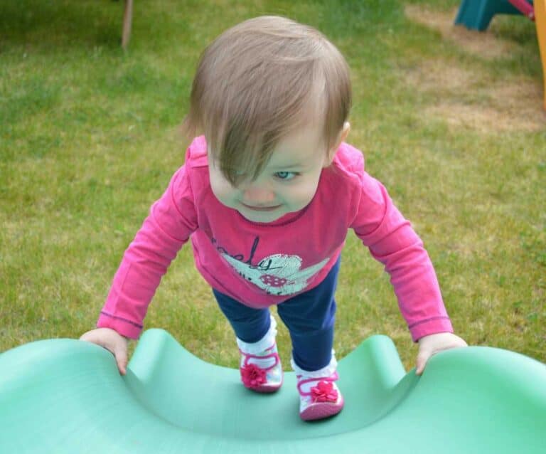 A small child sitting on a table