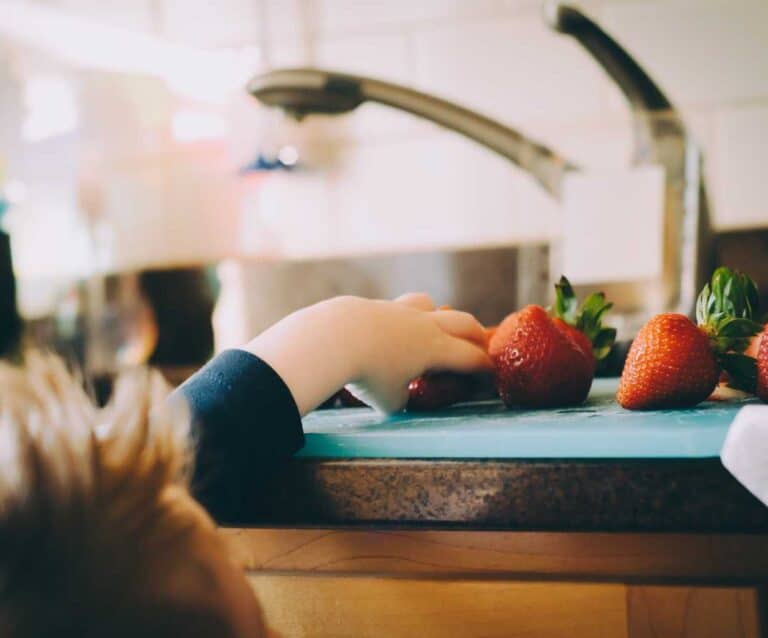 A person sitting at a table in front of a mirror