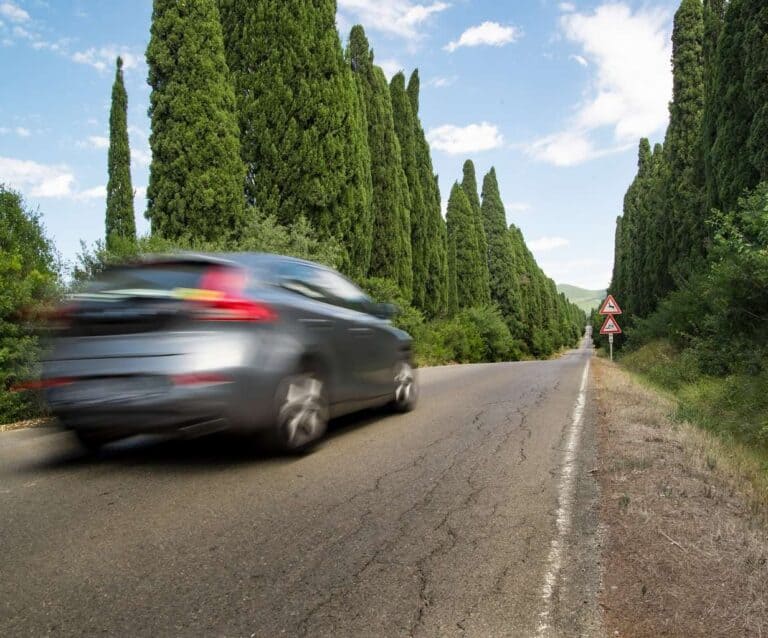 A close up of a car going down the road
