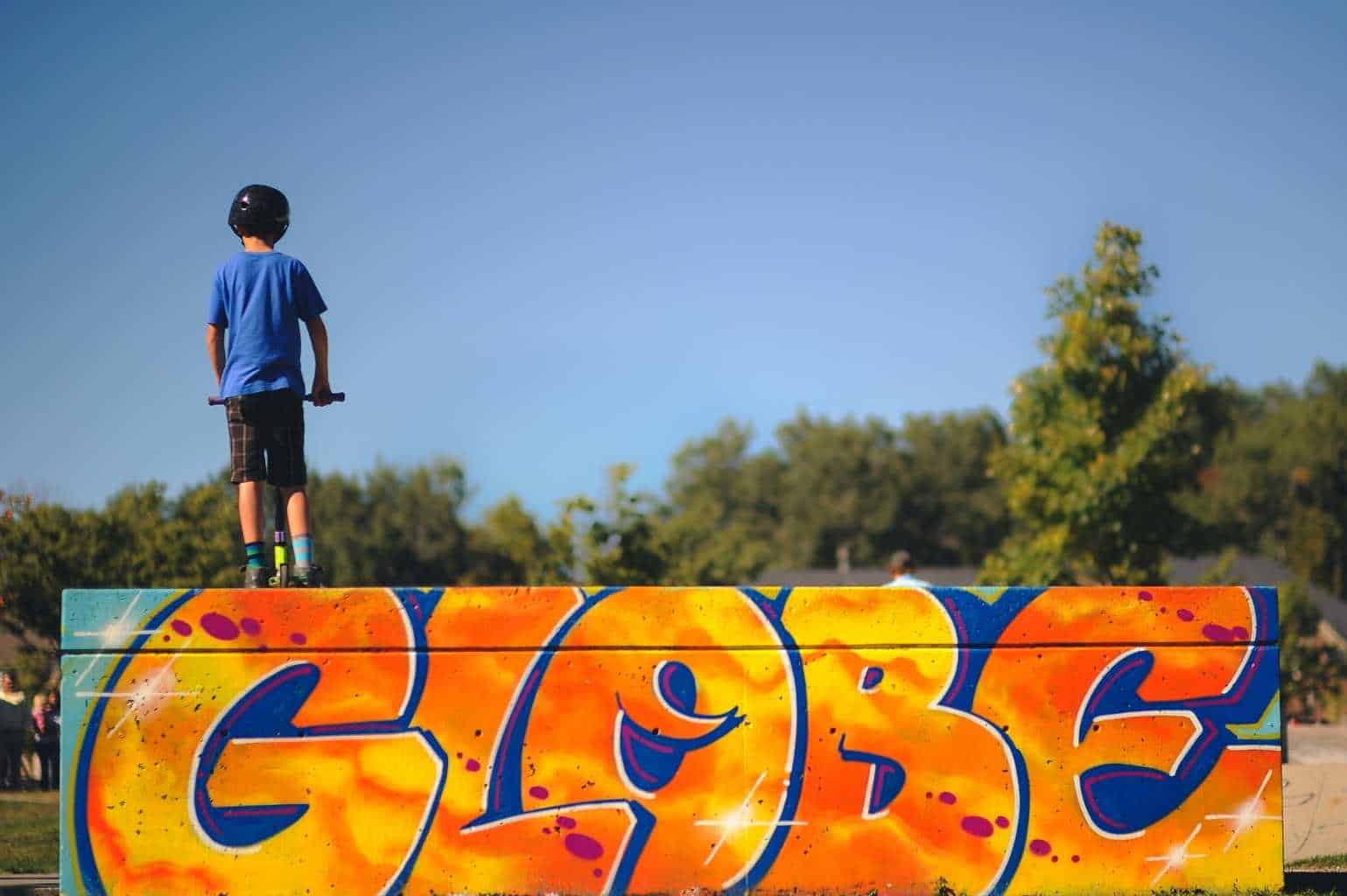 5 Outdoor Activities Your Kids Will Love - A man standing next to a graffiti covered wall