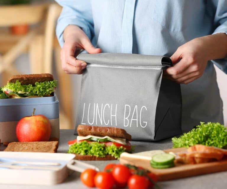 A person sitting at a table with a plate of food
