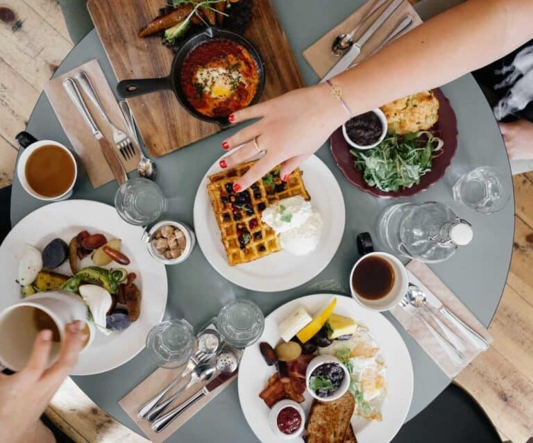 A group of people sitting at a table with a plate of food