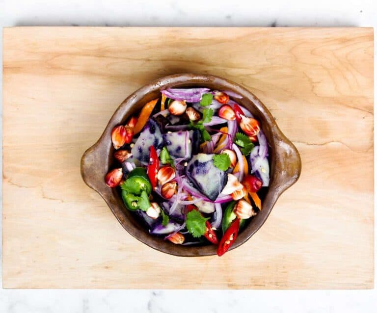 A pizza sitting on top of a wooden cutting board