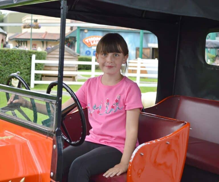 A little girl sitting on a bus