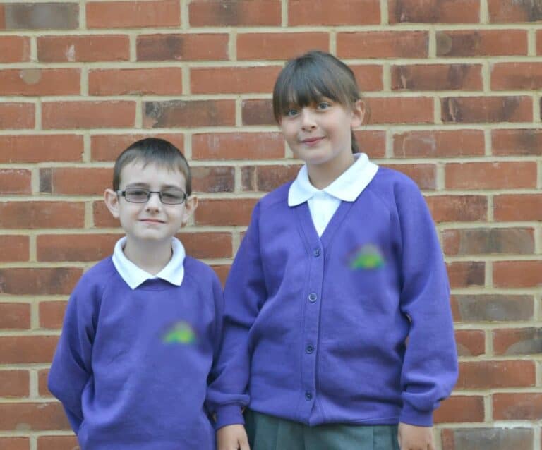 A person standing in front of a brick wall