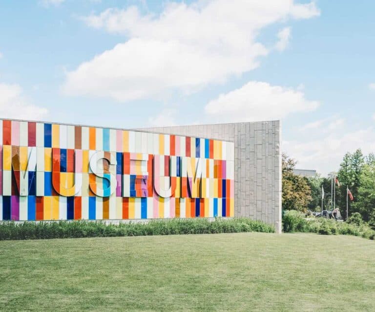 A colorful kite sitting on top of a grass covered field