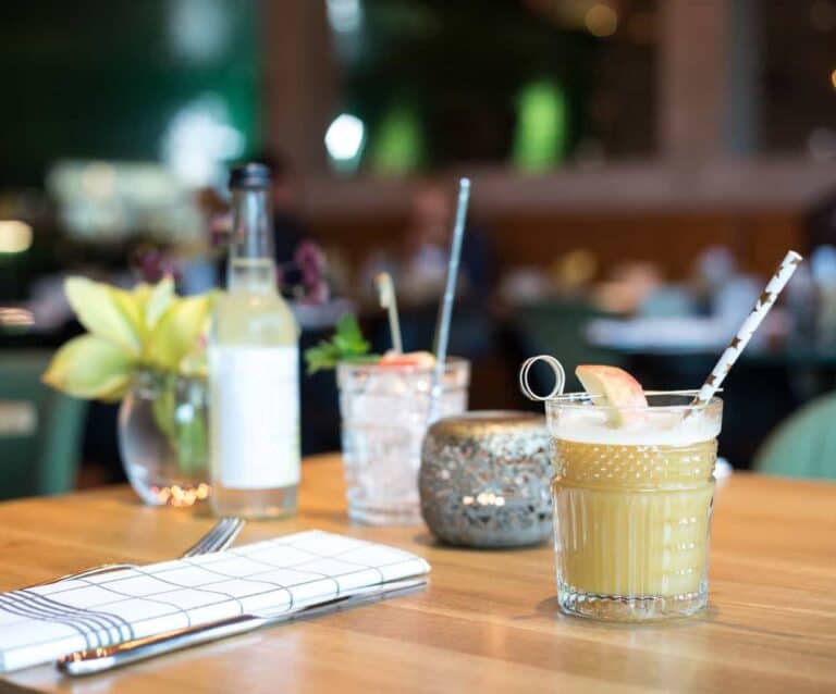 A cup of coffee sitting on top of a wooden table
