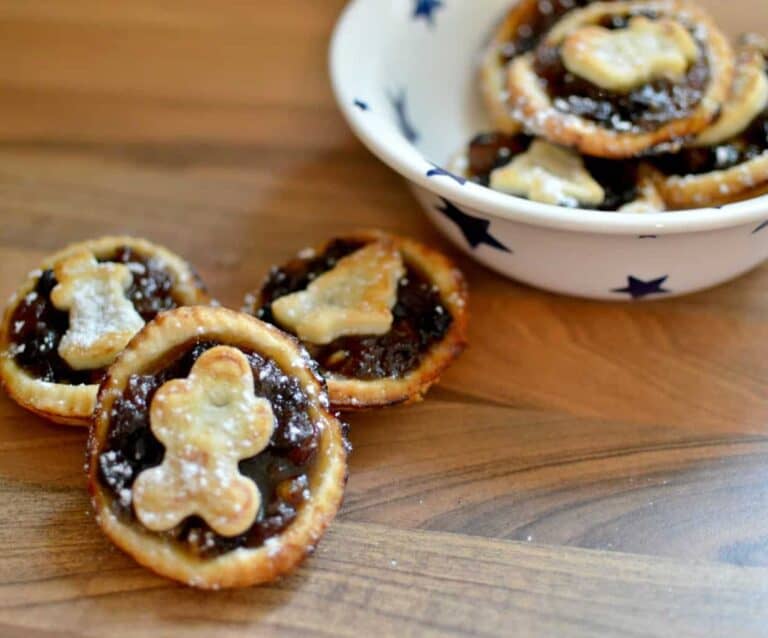 A bowl of food sitting on top of a wooden cutting board, with Pie