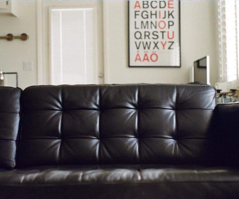 A brown leather couch in a living room