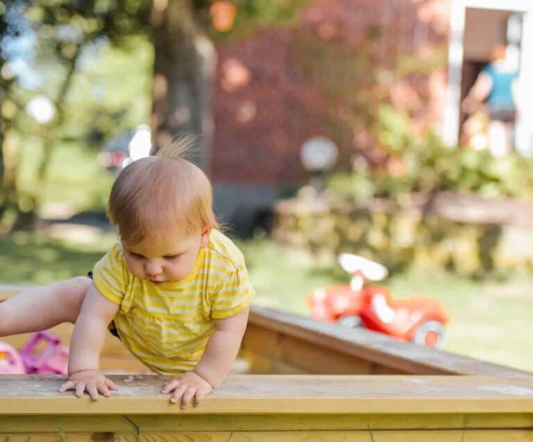 A little girl sitting at a picnic table