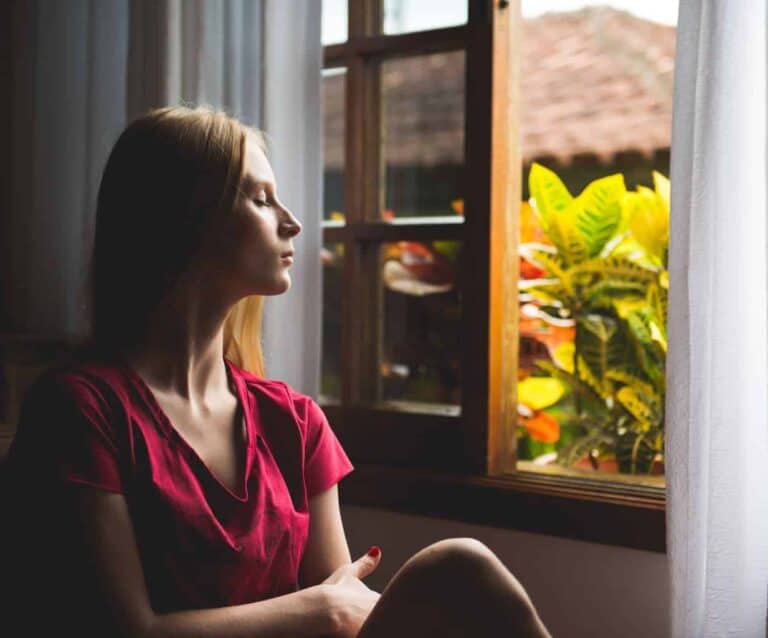 A woman standing in front of a window