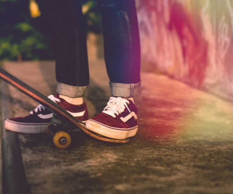 A pair of feet wearing blue shoes