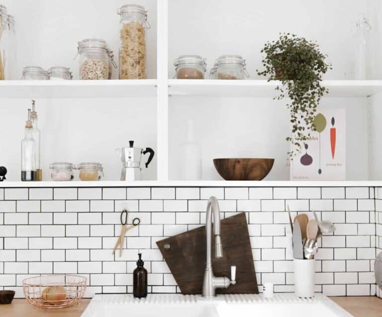 A kitchen with a sink and a mirror