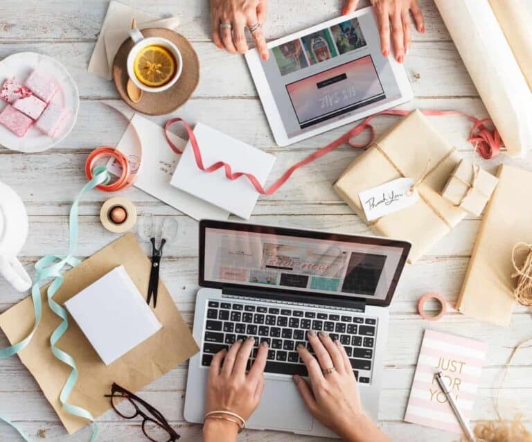 A group of people sitting at a table with a laptop