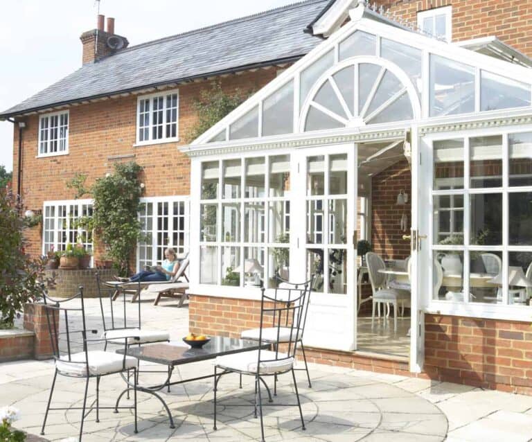 A bench in front of a brick building