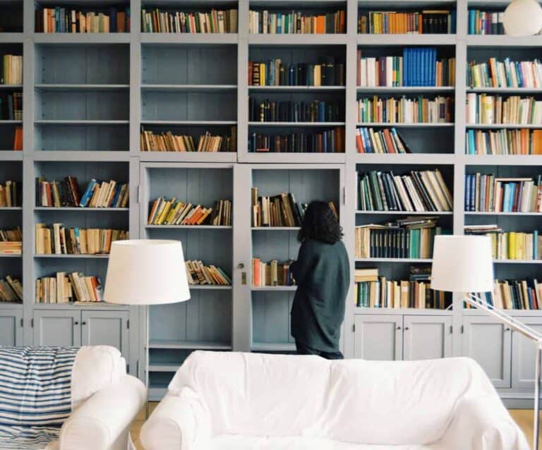 A room with a book shelf filled with books