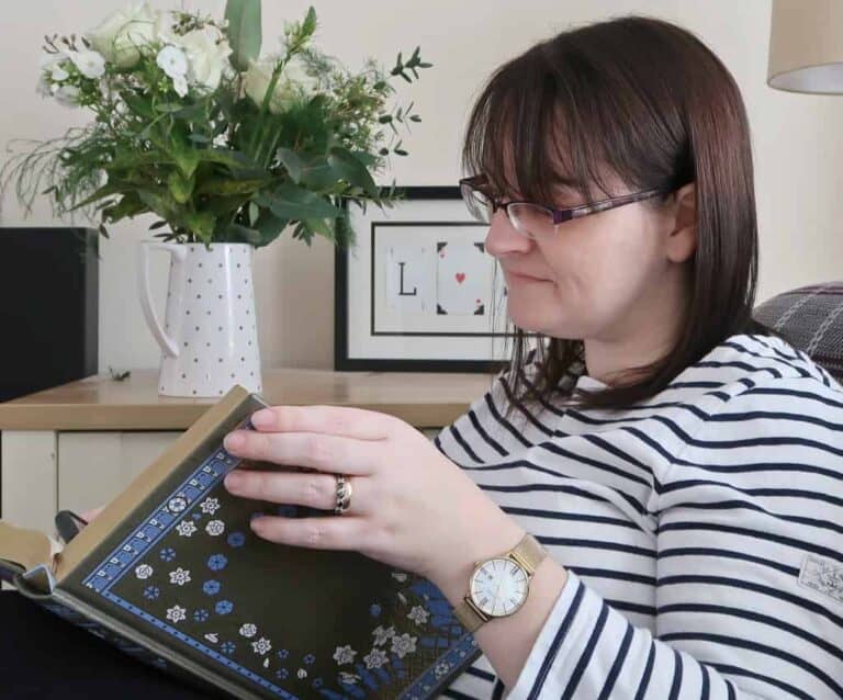A woman sitting at a table using a laptop