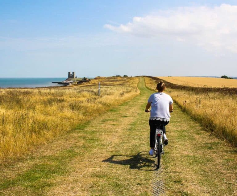 A person riding a bike down a dirt road