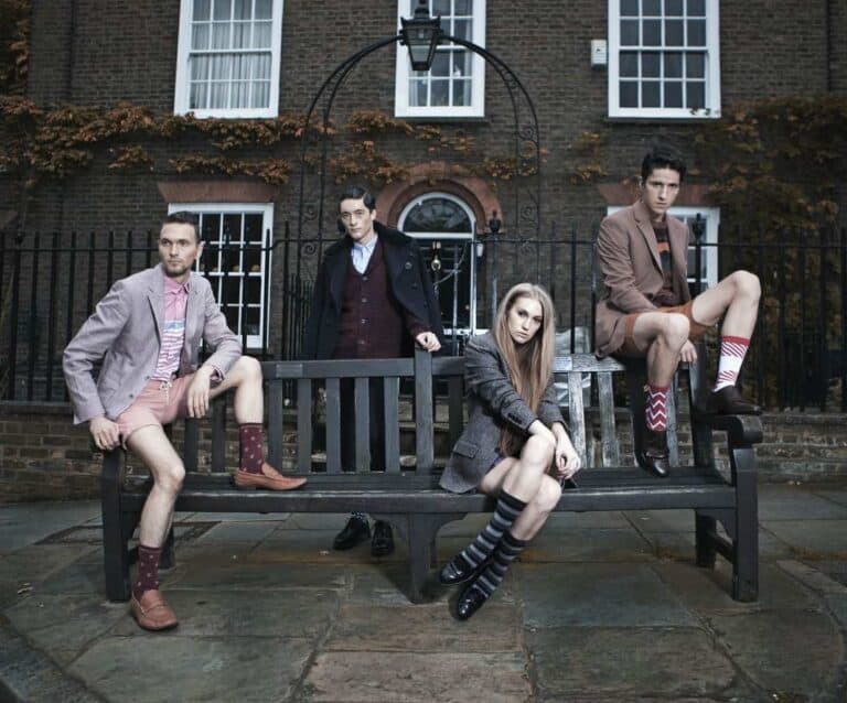 A person sitting on a bench in front of a building