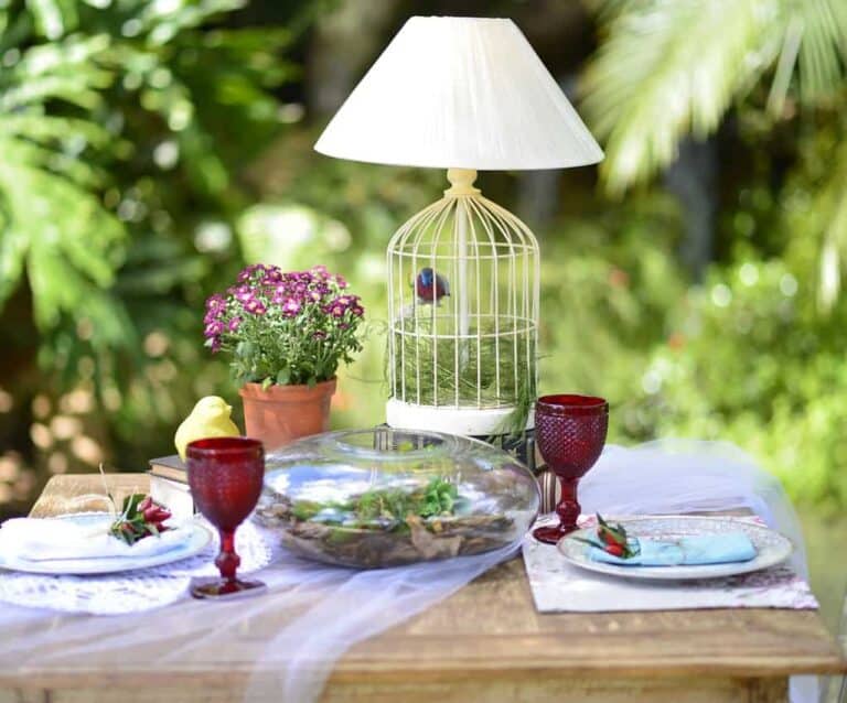 A glass of wine sitting on top of a picnic table, with Wood