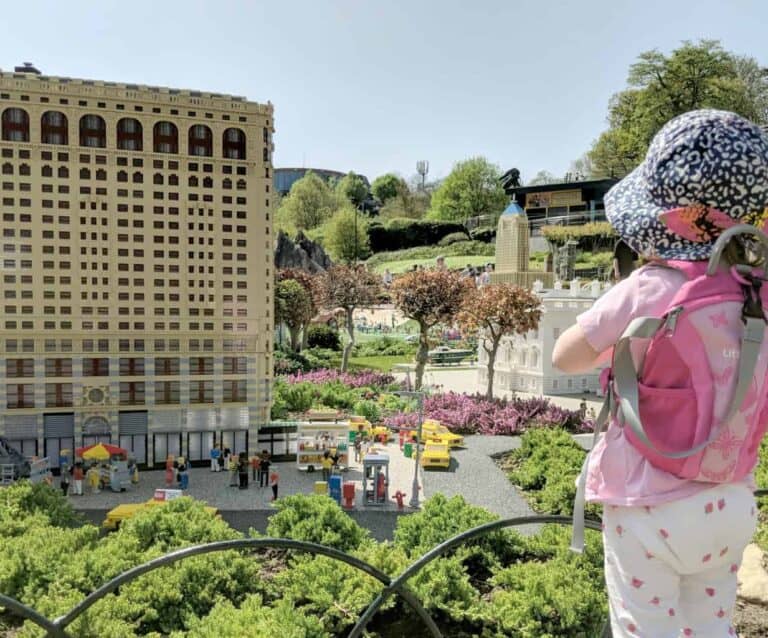 A little girl standing in front of a building