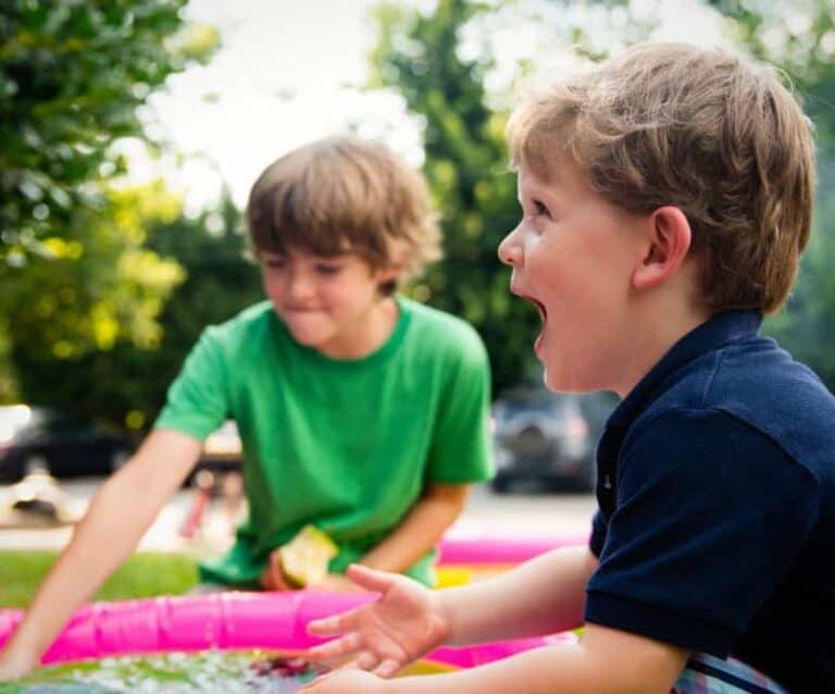 A little boy that is standing in the grass