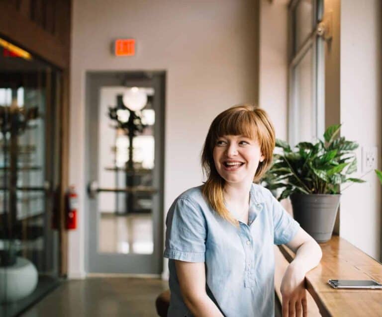 A woman standing in front of a window