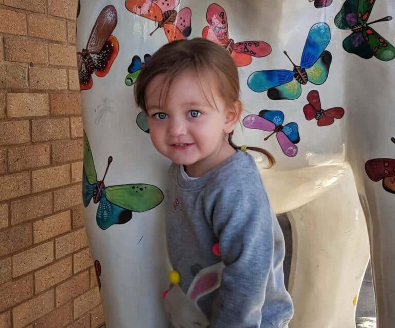A little boy that is holding a stuffed animal