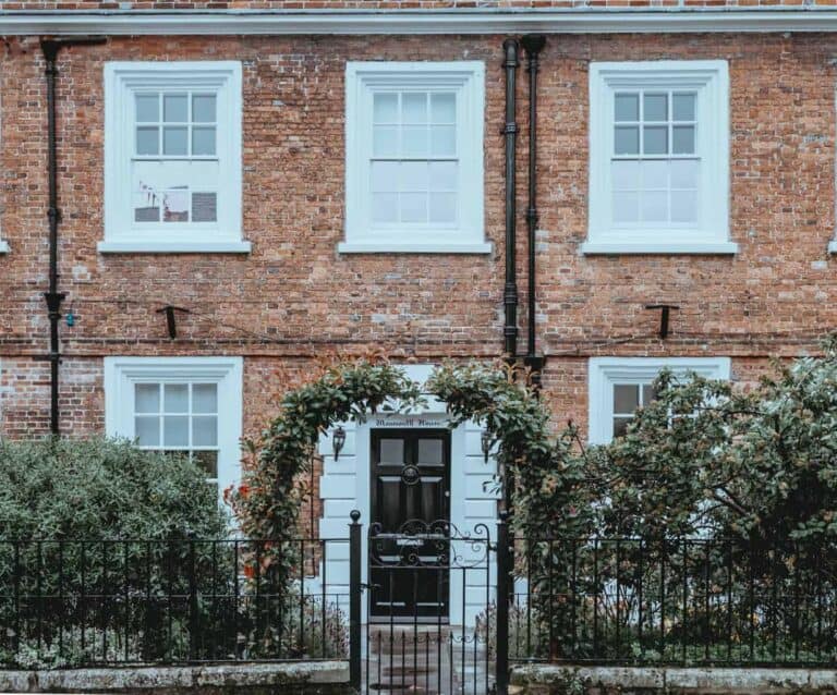 A bench in front of a brick building