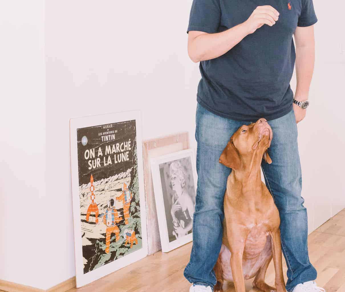 A man standing next to a dog